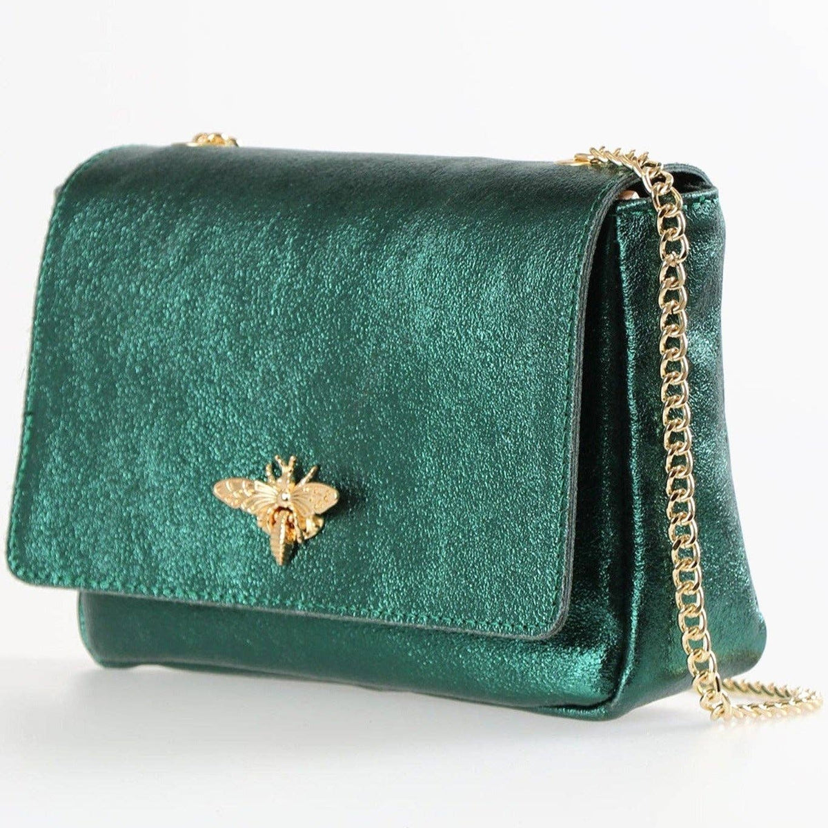 Green velvet handbag with a gold chain and bee emblem on a white background