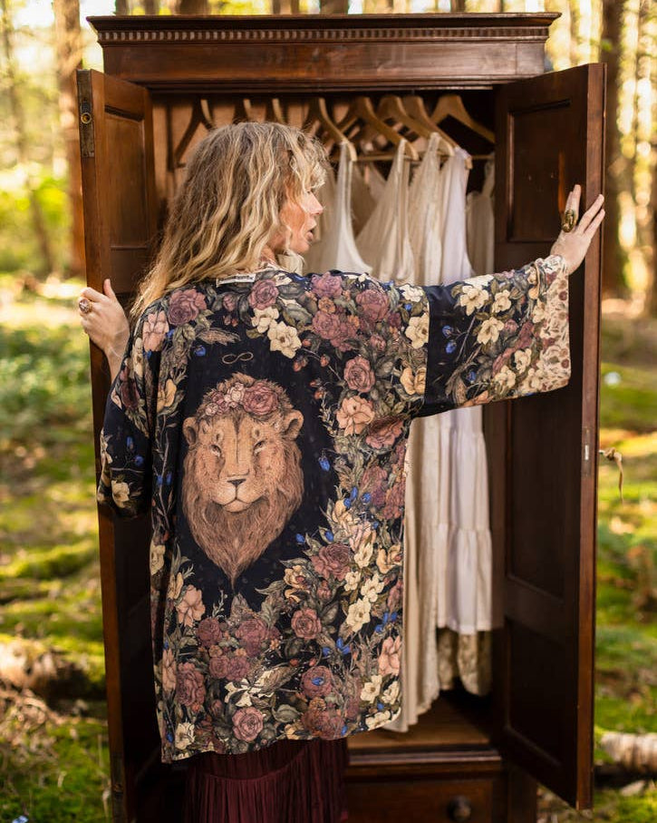 Woman wearing a floral kimono with a lion design in a forest setting